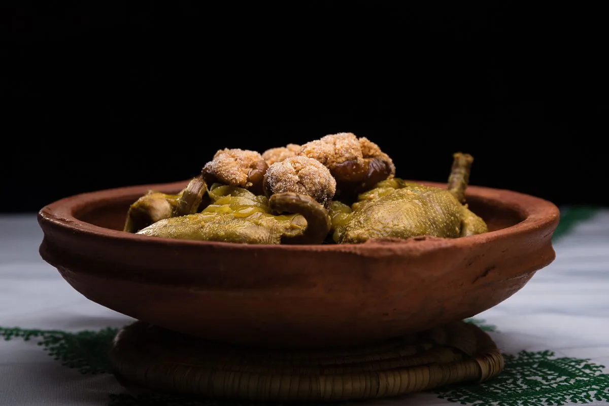 Pigeon with dates served on a carved wooden platter