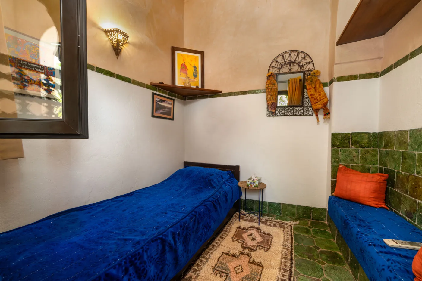 Riad guest room with earthen walls and woven textiles